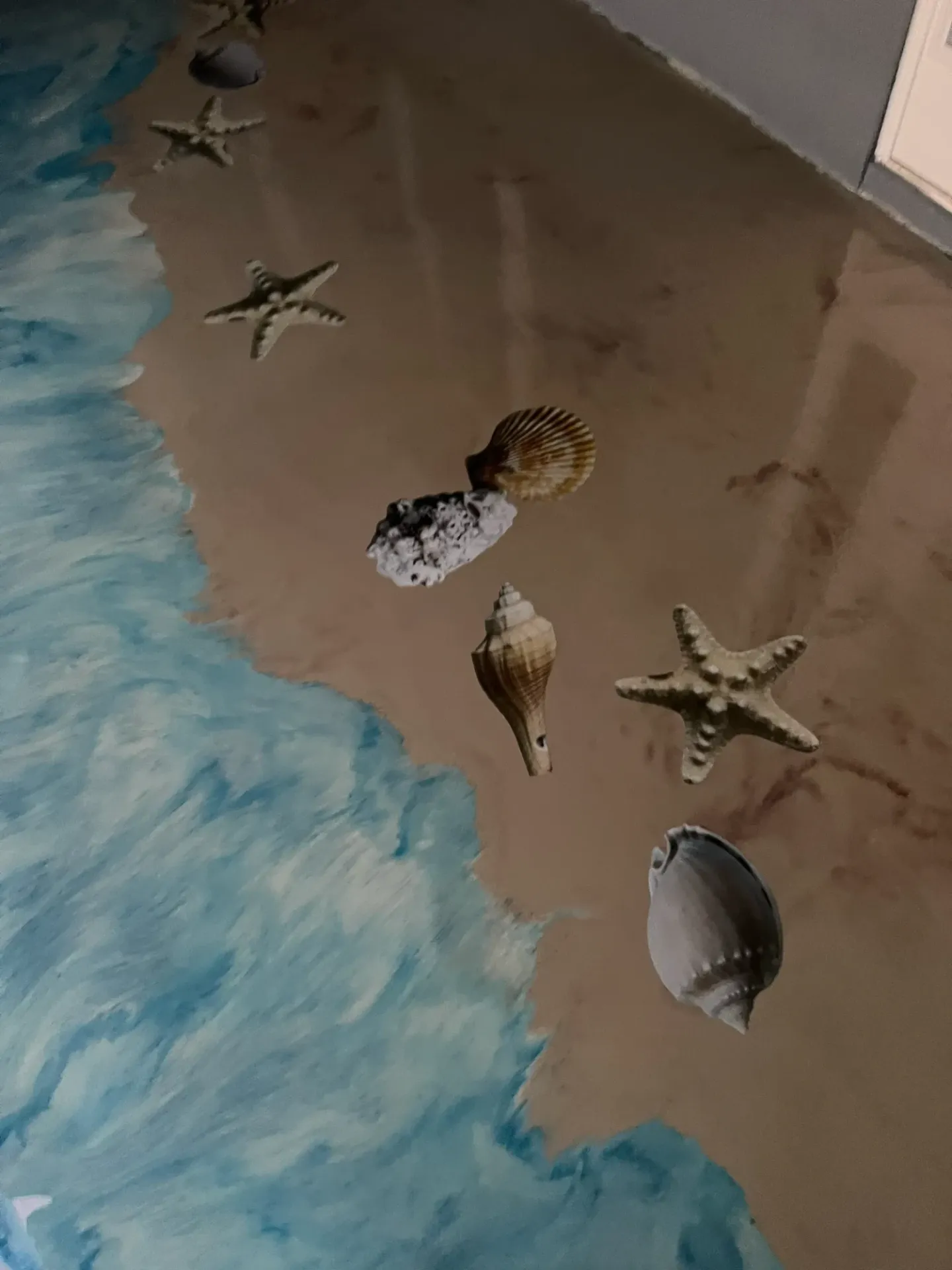 Ocean-themed decorative floor with waves and marine imagery.