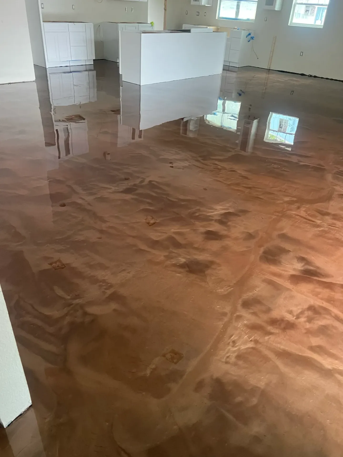 Brown decorative floor with flowing swirl patterns.