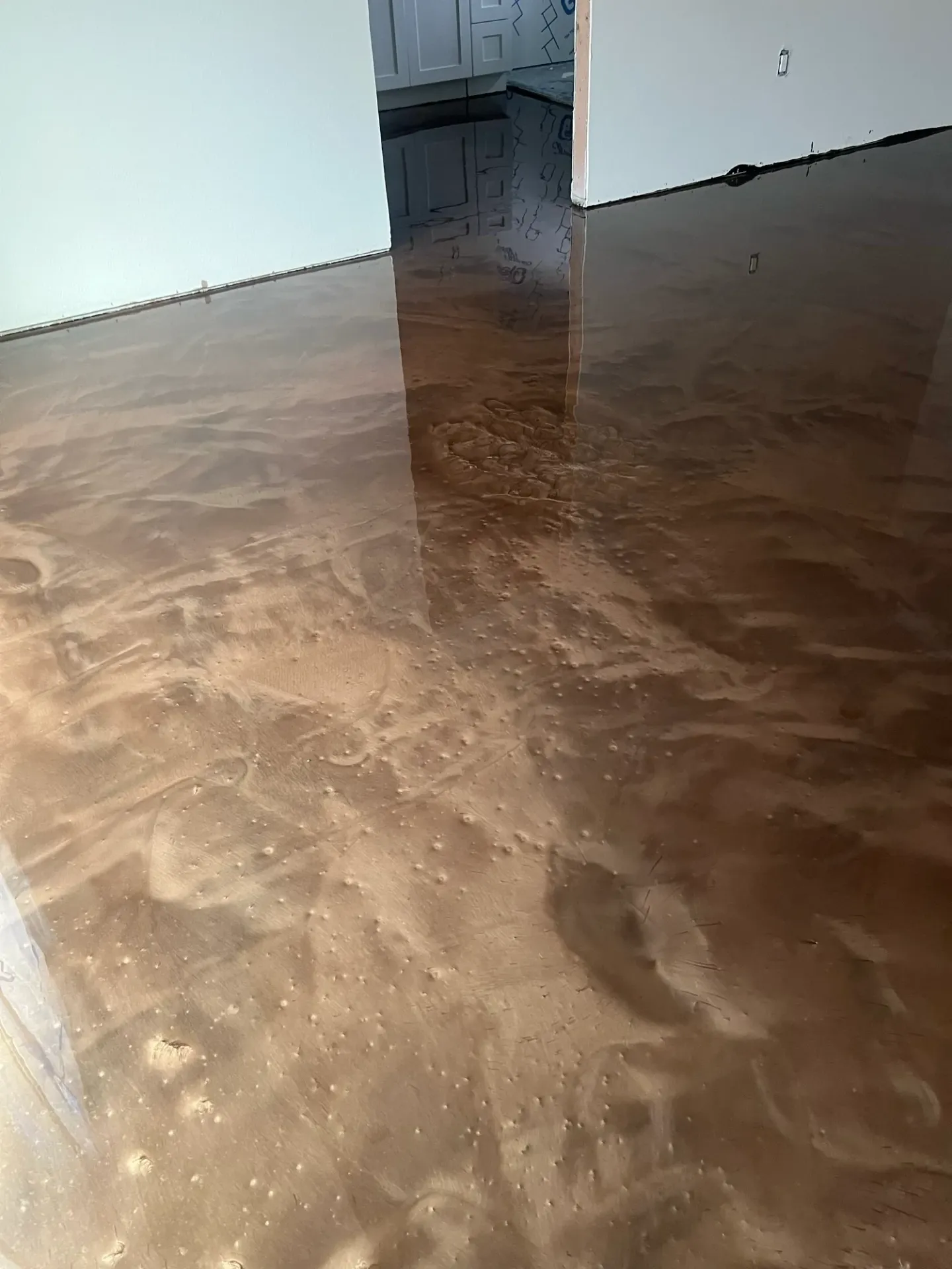 Brown decorative floor with flowing swirl patterns.