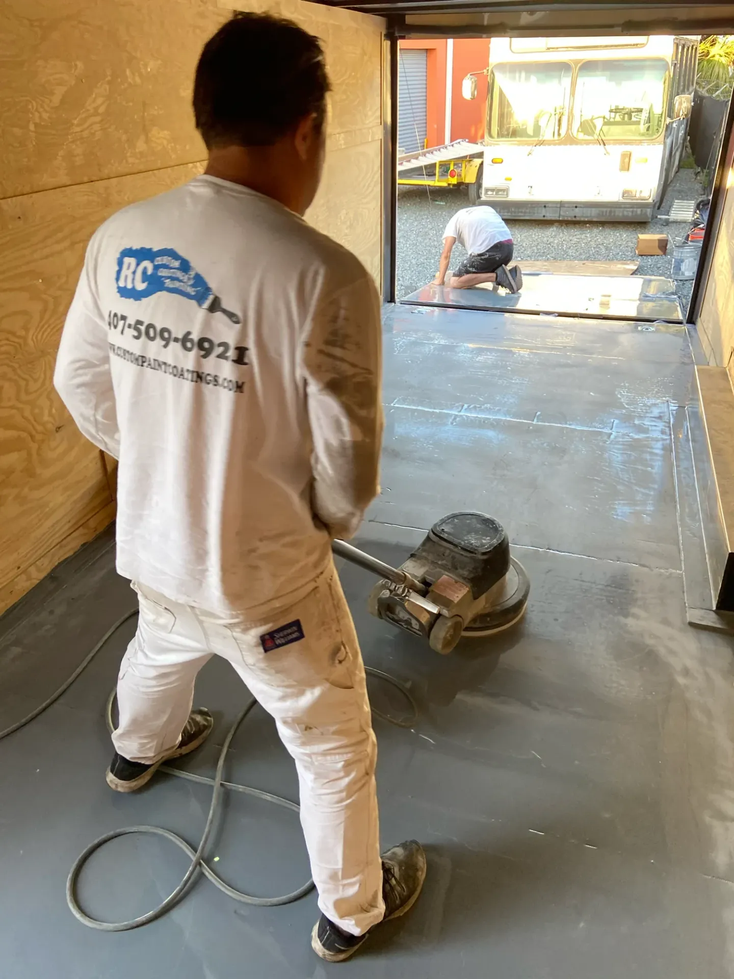Coating work and reflective flooring inside an enclosed trailer.