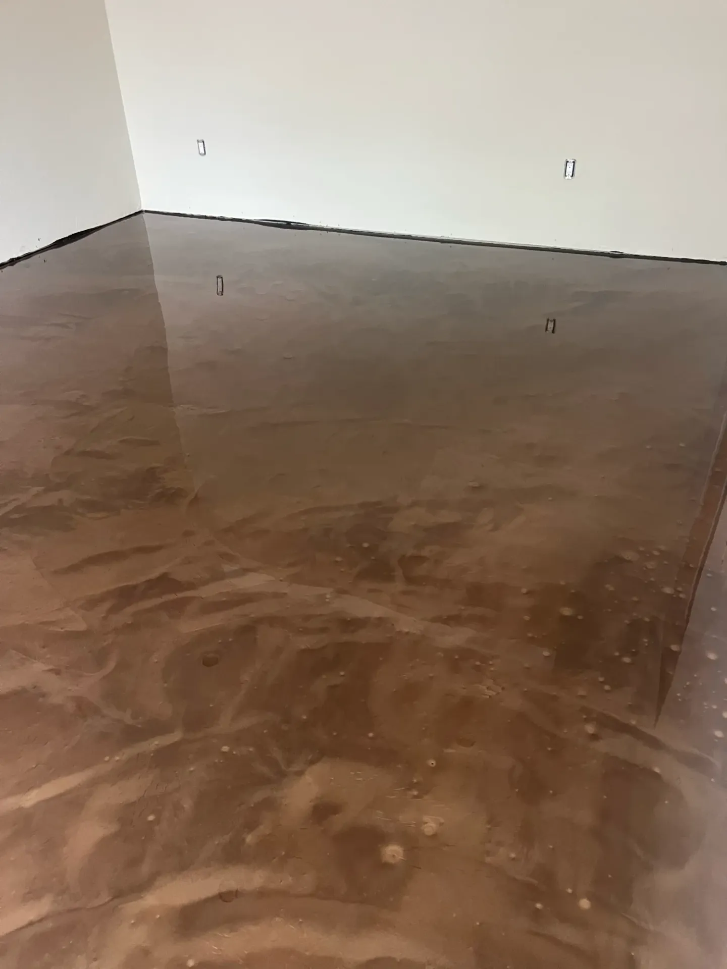 Brown decorative floor with flowing swirl patterns.