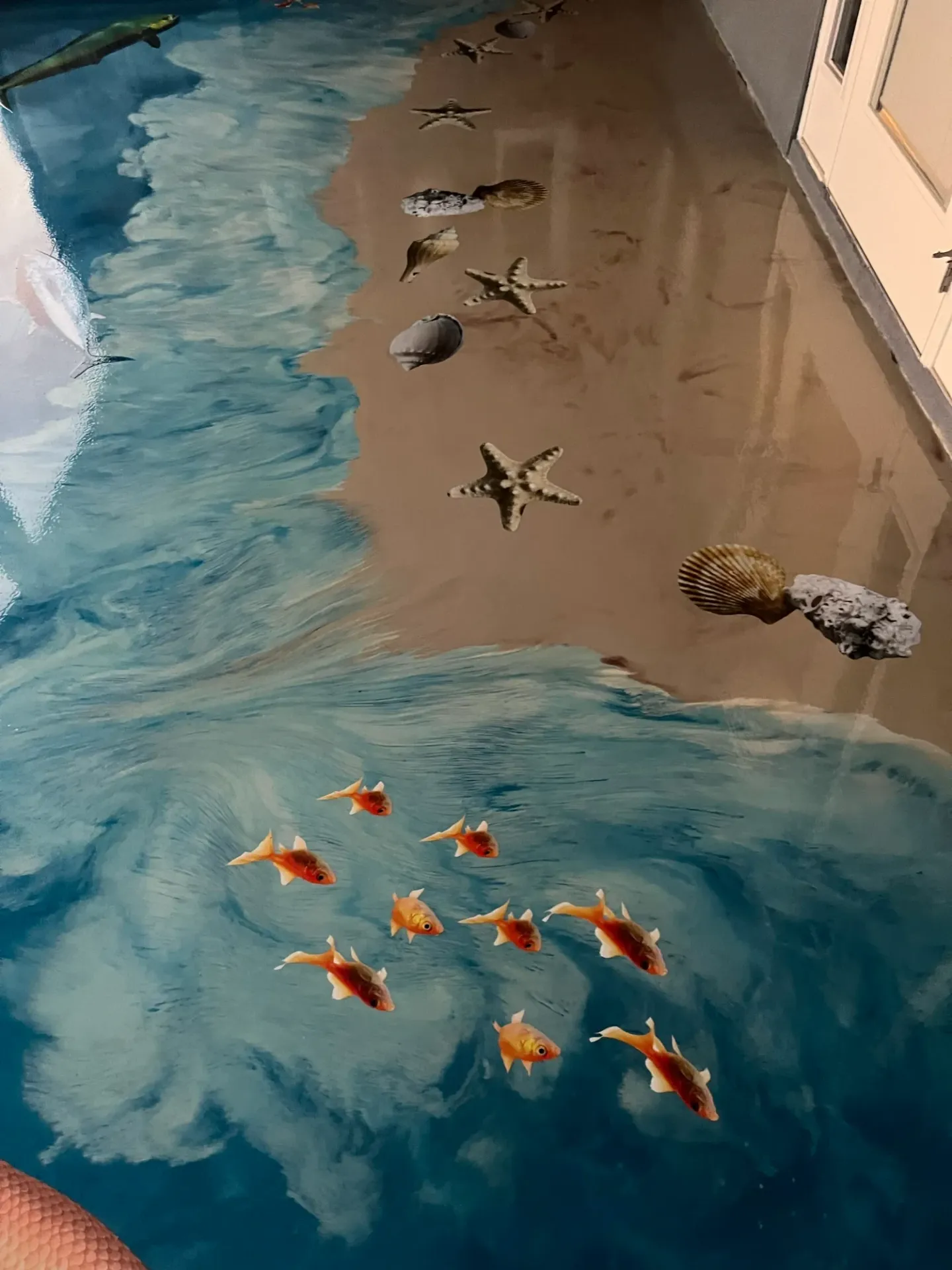 Ocean-themed decorative floor with waves and marine imagery.