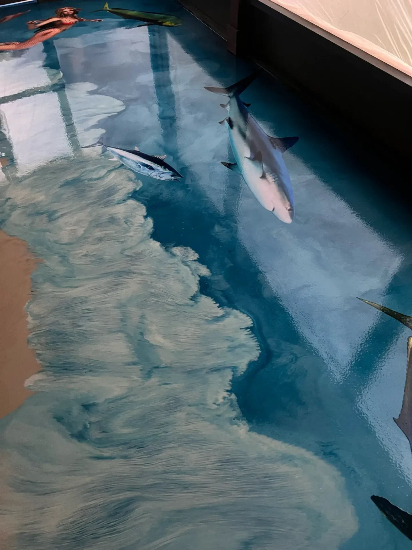 Ocean-themed decorative floor with waves and marine imagery.