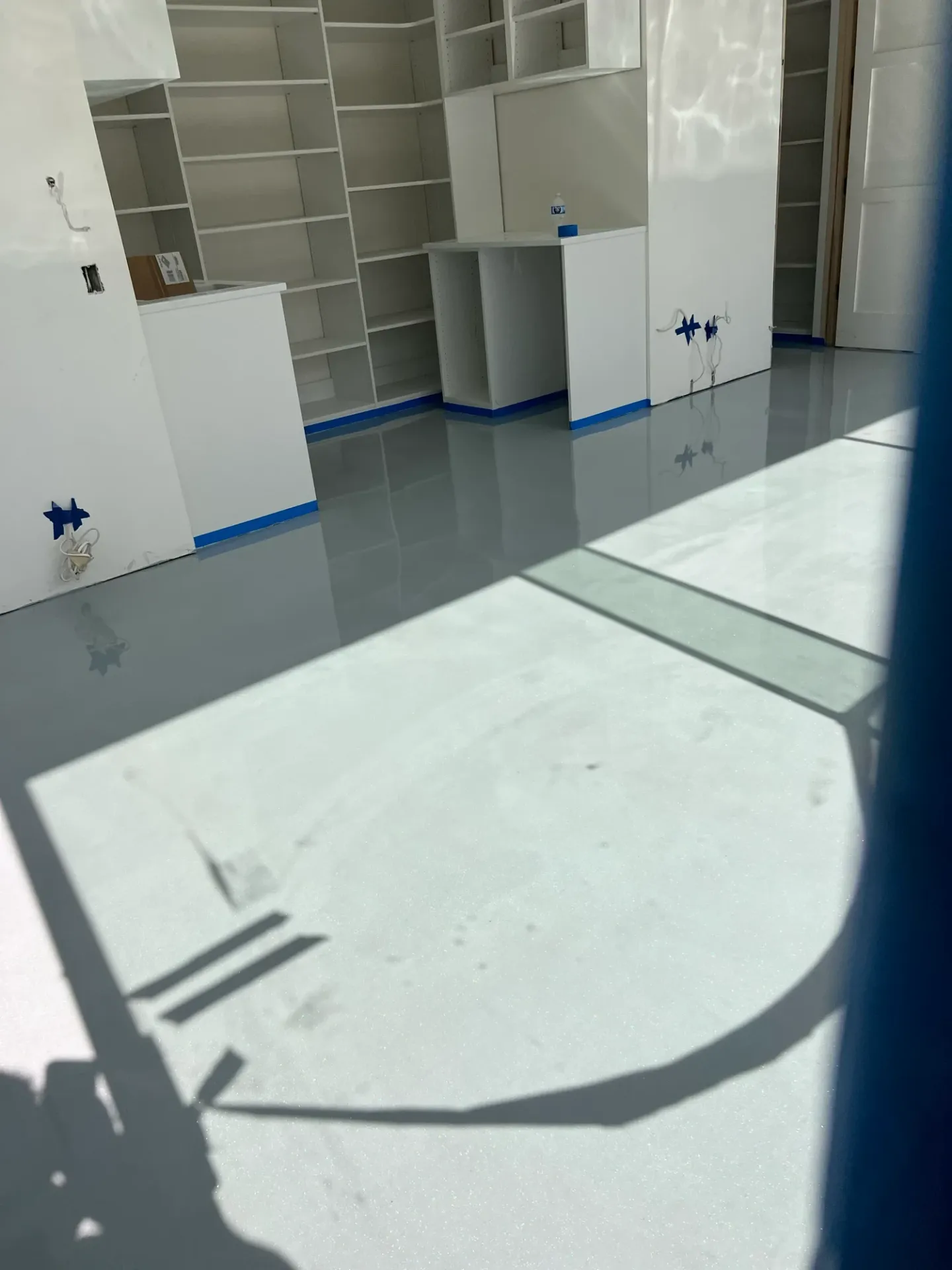 Reflective light-colored floor beside built-in storage.