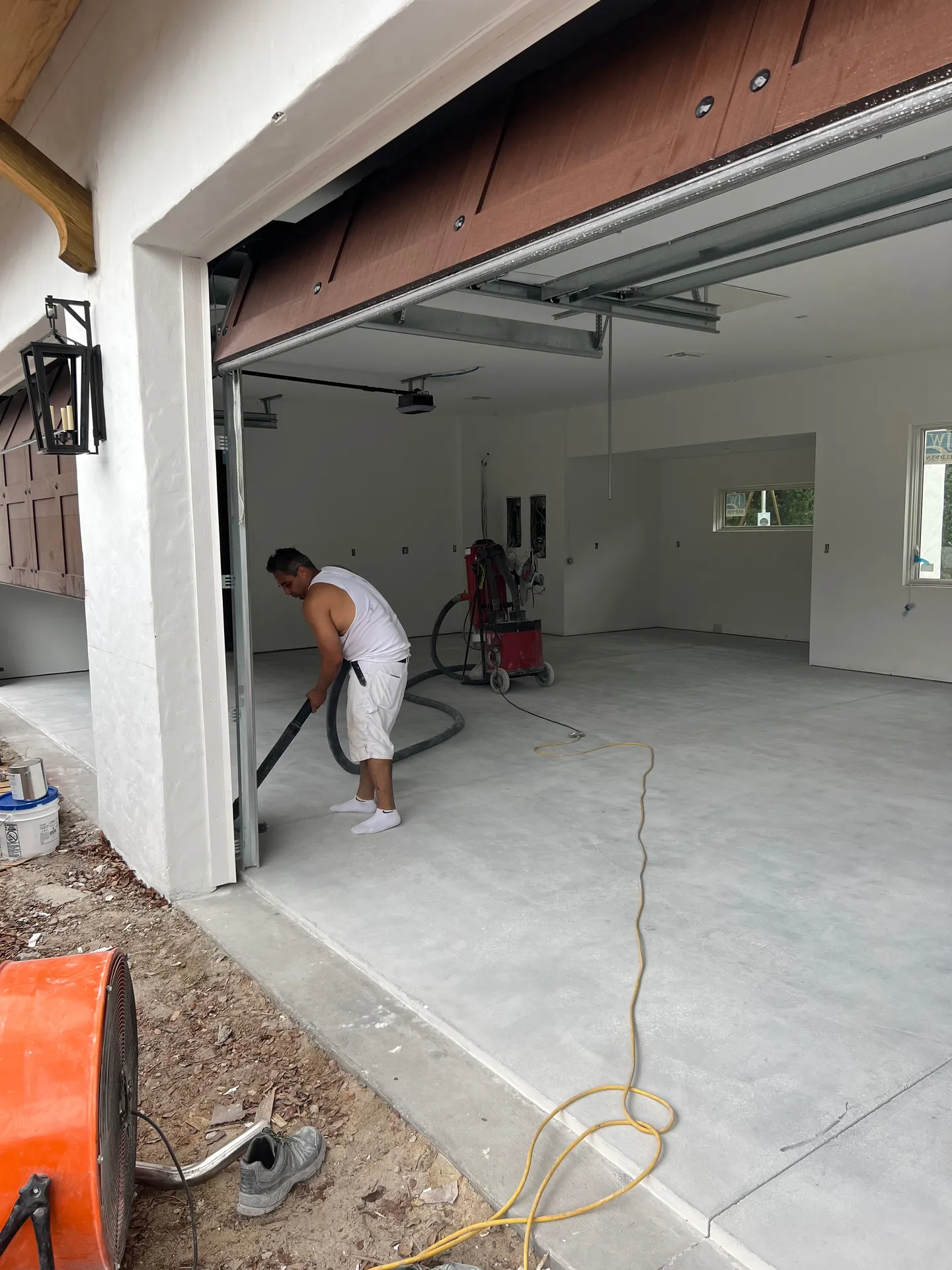 Concrete garage floor and surface-preparation work.