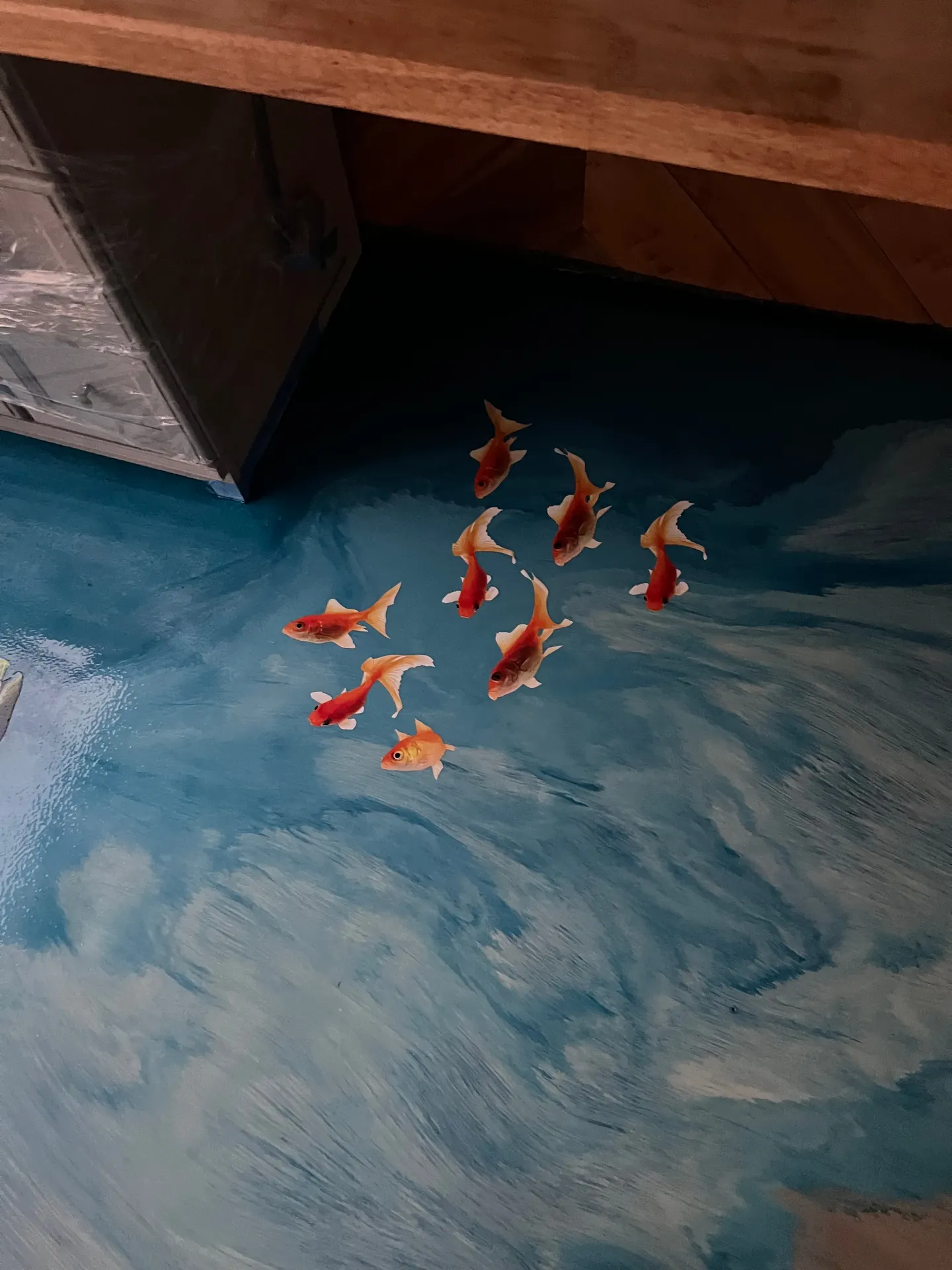 Ocean-themed decorative floor with waves and marine imagery.